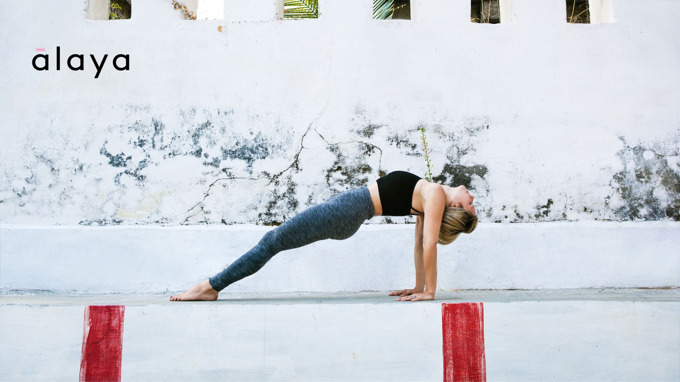 Online Ashtanga teacher Melissa demonstrating arm strength in a dynamic pose from the Primary Series