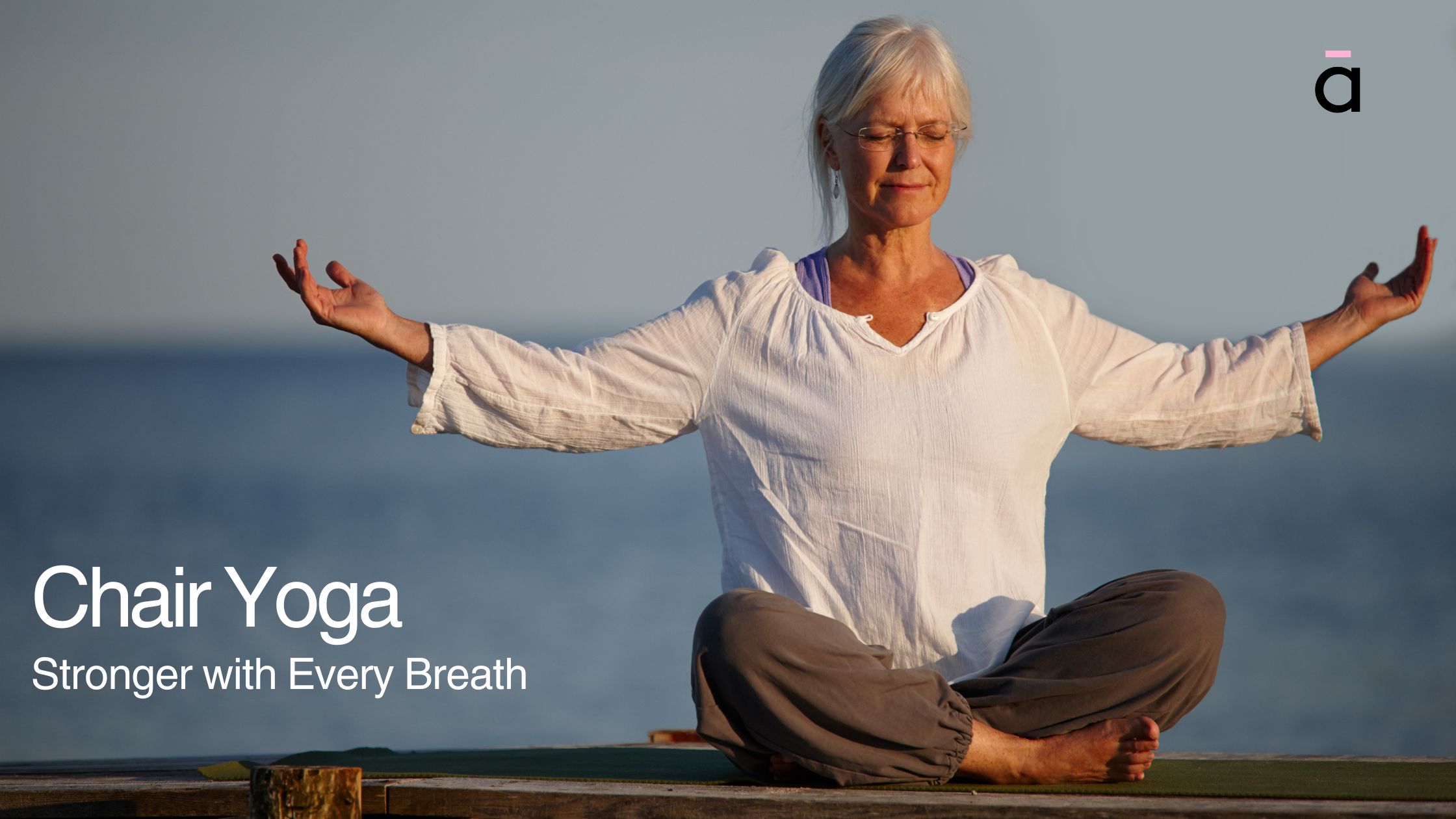 Elderly woman meditating outdoors in a seated yoga position with arms open, promoting peace and wellness
