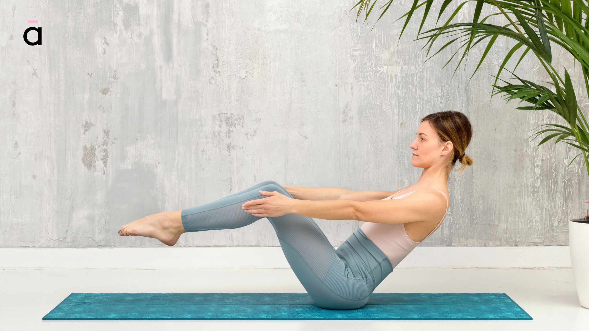 Person lying on a mat in tabletop position, arms extended and head lifted while practising The Hundred Pilates exercise