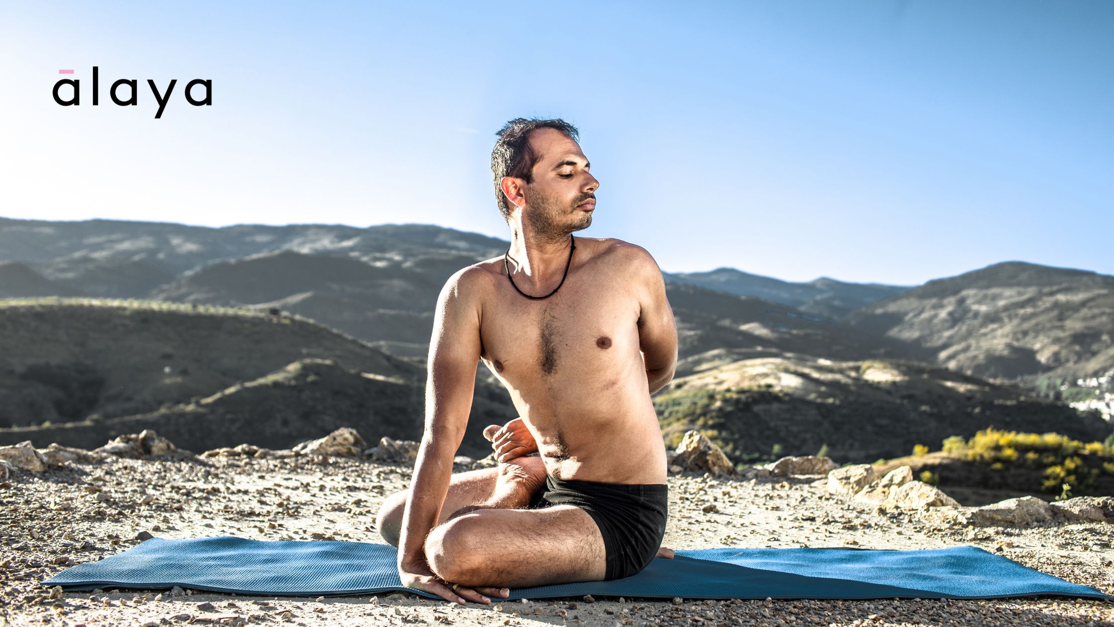 Yogacharya Lalit practising a seated spinal twist in nature, embodying traditional Ashtanga yoga principles