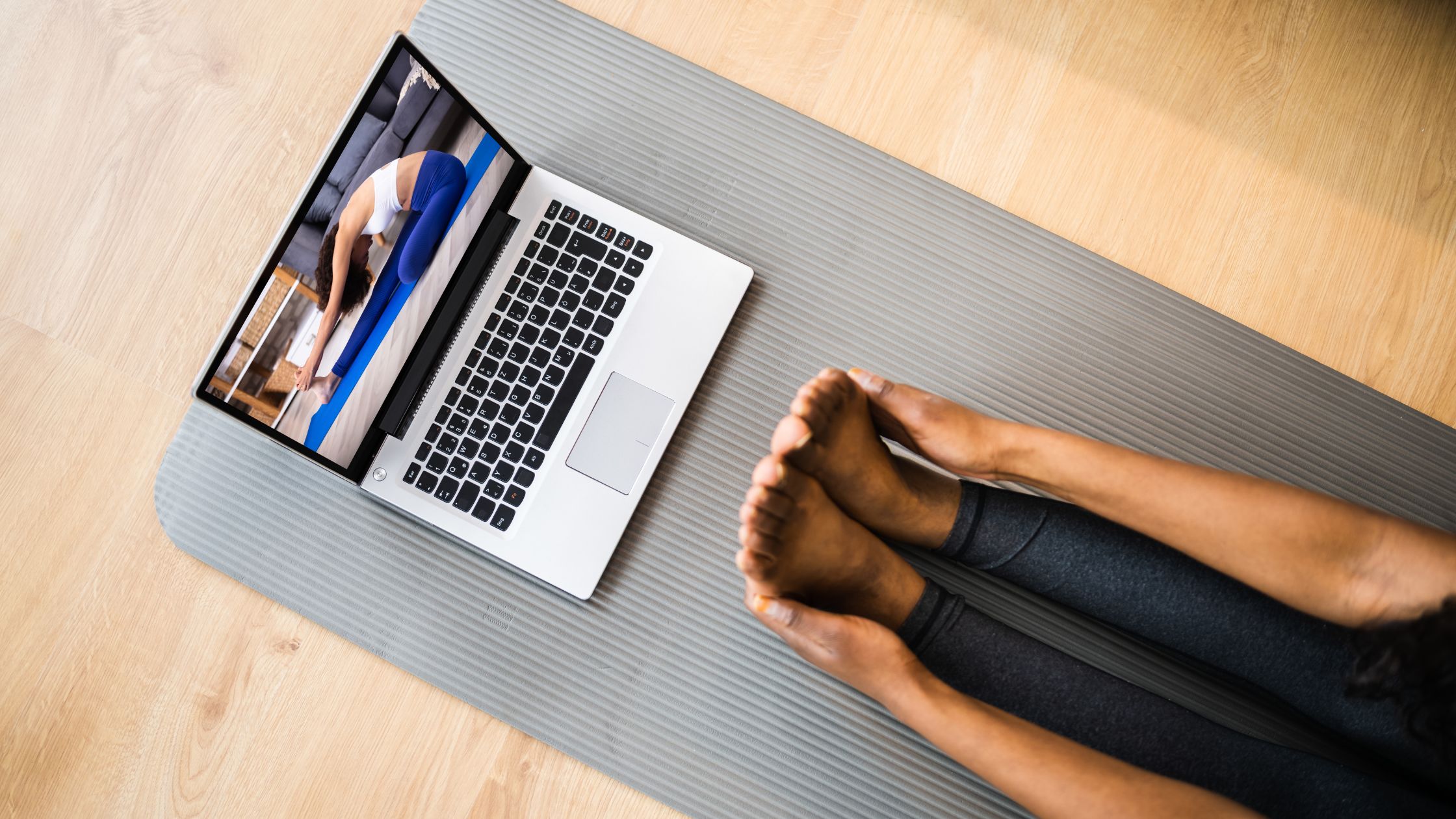 Person placing a yoga mat in their living room at sunrise, preparing for a daily morning yoga habit.”