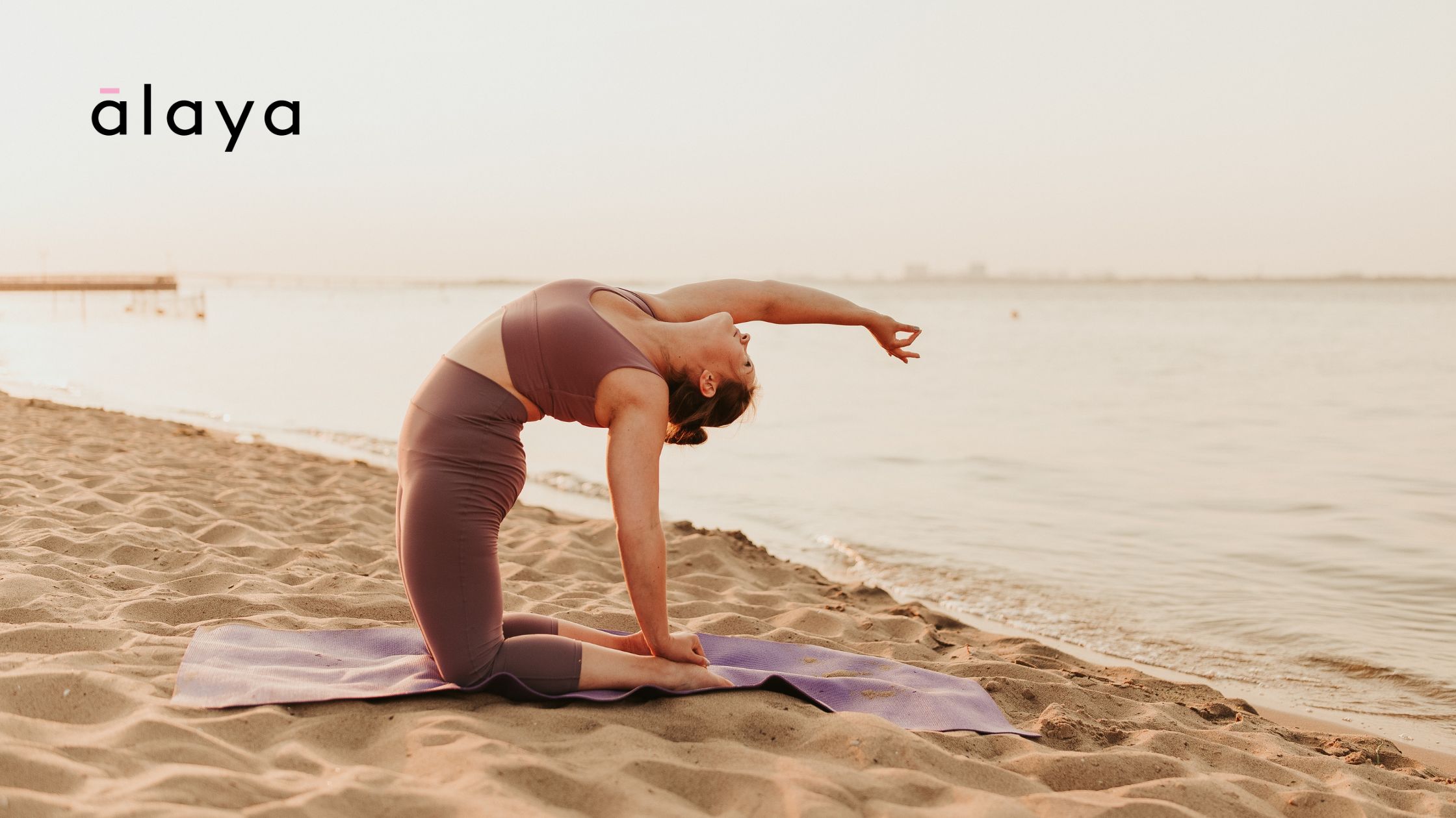 Woman at the beach doing a 15-minute morning yoga routine.