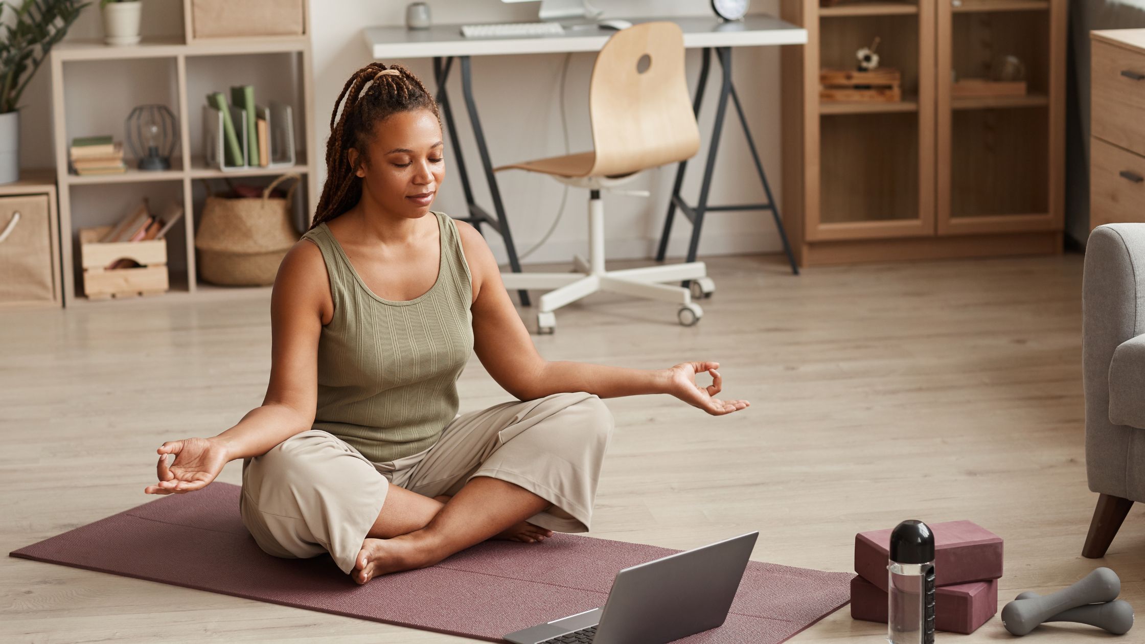 Practitioner flowing through a beginner-friendly morning yoga sequence on a mat at home.